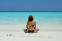  woman sitting on the beach